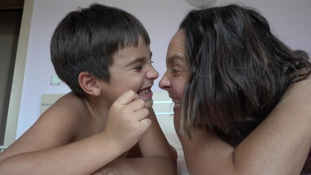 Fethiye, Turkey - 7th of August 2021: 4K Selfie Funny mother with her child bark and bare teeth on each other
