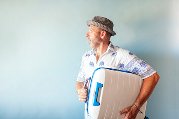 Men looking to the side and with suitcase on summer vacation.