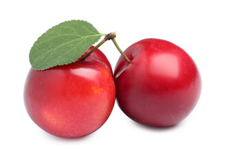 Delicious ripe cherry plums with leaf on white background