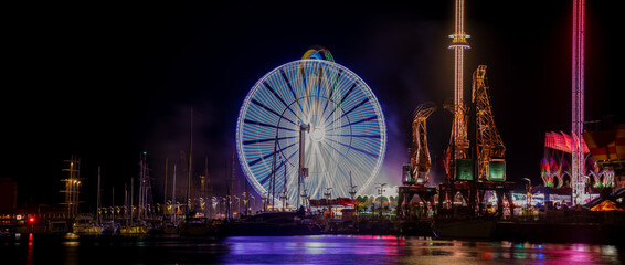Szczecin, Poland, July 2021: Night amusement park, beautiful illuminations photographed in motion