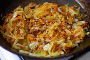 Preparation for a dish for lunch. Fried vegetables in a pan.