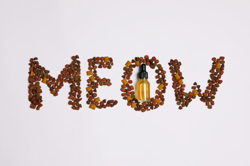 Tincture and word Meow of dry pet food on light background, flat lay