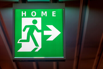 The emergency exit sign indicates the direction of way to home.