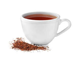 Aromatic rooibos tea in ceramic cup and scattered dry leaves on white background