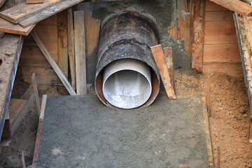 City communications. Laying a sewer pipe in a pit. Fragment of underground engineering works and...