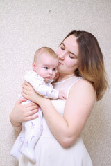 home photos of a young mother with a small child. Newborn boy. Cute, cozy photos with a baby.
