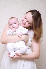 home photos of a young mother with a small child. Newborn boy. Cute, cozy photos with a baby.