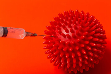 medical needle penetrates the body of COVID-19 virus