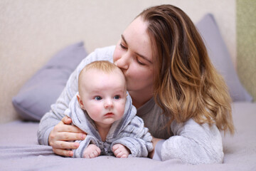 home photos of a young mother with a small child. Newborn boy. Cute, cozy photos with a baby.