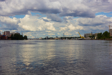 Fototapeta na wymiar Industrial and residential buildings on the banks of the Neva river in St. Petersburg