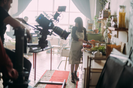 Director at work on the set. Shooting shift, equipment and group. Modern photography technique.