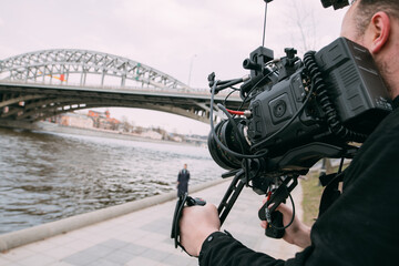 Director of photography with a camera in his hands on the set. Professional videographer at work on filming a movie