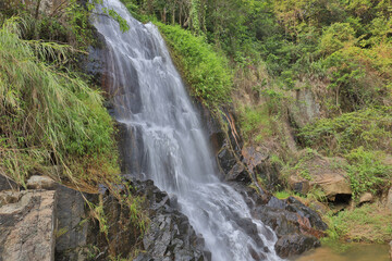 Fototapeta na wymiar water flow at the main fall of the Silvermine Waterfalls on the Lantau 23 July 2021