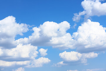 Naklejka na ściany i meble Beautiful white fluffy clouds in blue sky