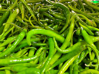 Freshly plucked raw green chillies kept at a supermarket stall 