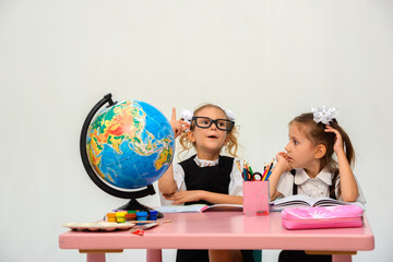 two schoolgirls doing homework. study, write, paint on a white background. isolate