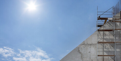 Scaffolding, metal mobile scaffold aginst blue sky background. Banner.