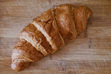 Close-up of freshly baked croissant on wooden table