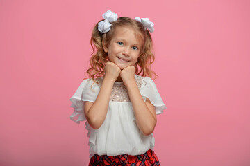 portrait of a cute schoolgirl with different emotions Isolated on pink background