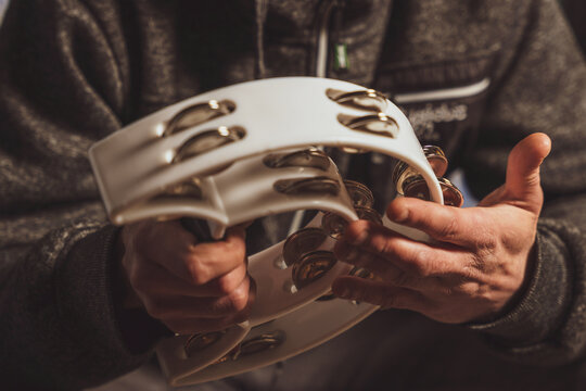 Musician playing the headless tambourine, selective focus