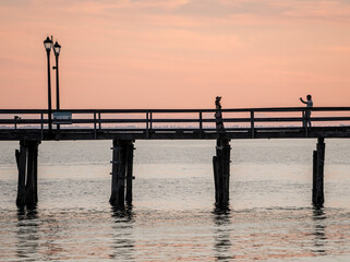 couple in a pier at sunset