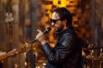 Fototapeta na wymiar Male singer in sunglasses, rock band