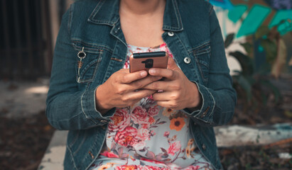 latin woman checking text messages on mobile