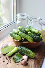 Fresh cucumbers on a wooden table. Dill, garlic and spices. Preparation of pickled cucumbers. preservation of fresh homemade cucumbers. Selective focus. nature