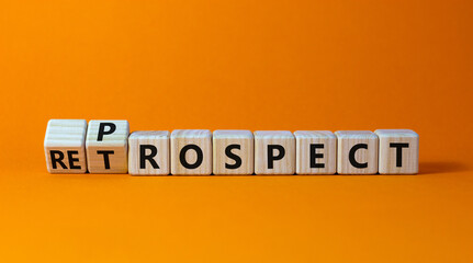 Prospect or retrospect symbol. Turned a cube and changed the word 'retrospect' to 'prospect'. Beautiful orange background. Business and prospect or retrospect concept. Copy space.