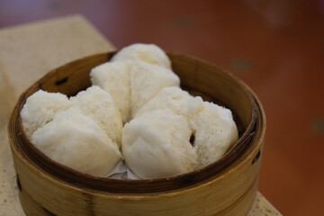 Fototapeta na wymiar close up steamed bun stuffed with barbecued roast pork. Traditional Chinese dim sum