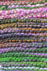 Fototapeta na wymiar hand knitting background texture in striped colourful yarn 