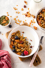 Homemade granola with milk honey nuts and fresh berries