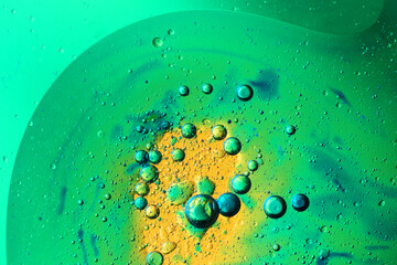 oil bubbles with water on glass