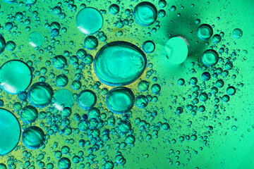 oil bubbles with water on glass