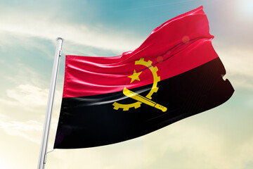 Angola national flag waving in beautiful sky. - obrazy, fototapety, plakaty