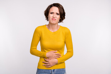Photo of exhausted sick girl hands touch belly grimace wear yellow shirt isolated grey color...