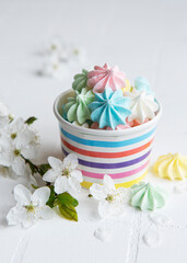 Small colorful meringues in the  paper bowl
