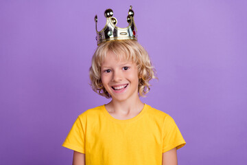 Photo of positive royal prince kid shiny white smile wear golden crown yellow t-shirt isolated violet color background