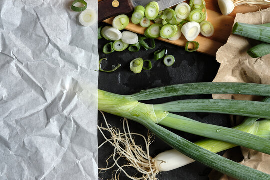 Fresh Negi, Japanese Green spring onions, Chopped Scallions on Wooden Board with Crumpled  Paper Notepad.