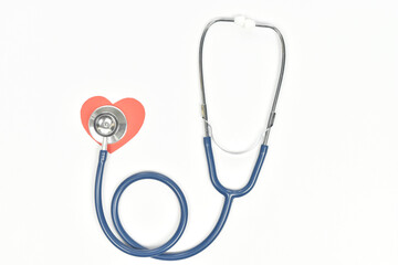 Top view of stethoscope and heart shape on white background.