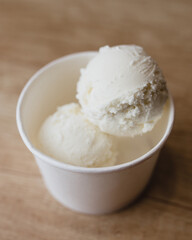 White creamy ice cream in the form of balls in a cardboard box