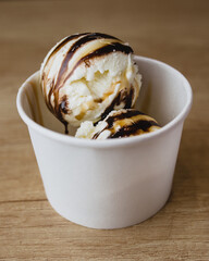 Balls of sweet creamy ice cream in a box - homemade dessert from mom to children - a favorite treat for the whole family