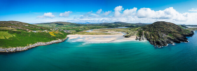 Fototapeta na wymiar Aerial view of Barleycove beach, a gently curving golden beach formed of an extensive landscape nestled in between the rising green hills of the beautiful Mizen Peninsula in west Cork