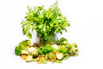 Green vegetables, fruits and herbs on a light background. Fresh parsley, dill, broccoli, peas, spinach. Vegetables and herbs for vegetarian food. Natural vitamins.