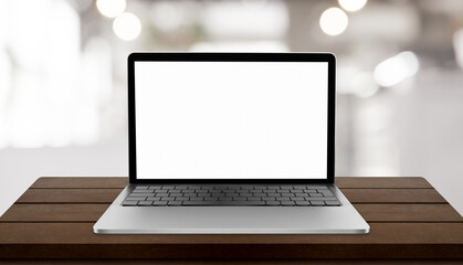Fototapeta premium Laptop with blank screen on table with blurred restaurant background