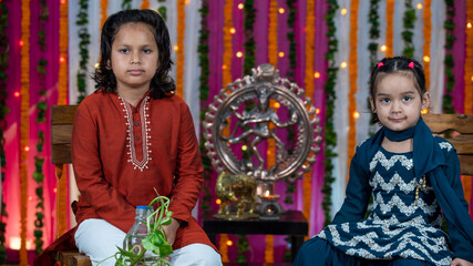 Obraz na płótnie Canvas Indian children wearing ethnic Indian dress during Raksha Bandhan, a festival to celebrate the bond between brother-sister. Decoration in Indian houses.