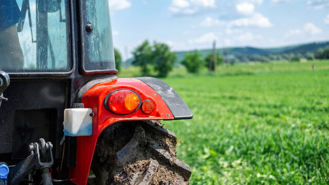 Fototapeta Rear view of a tractor in the nature