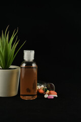 Medicine tablets and capsules come out from glass tube container with dark background