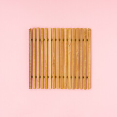 Bamboo sticks on light pink background.