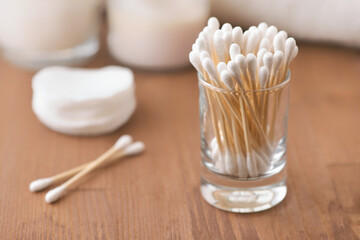 Natural cotton buds in glass container
